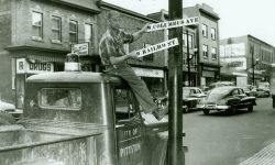 Petition Changes RailroadStreet To ColumbusAvenue - Man In Photo Changes Signs On Pole